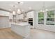 Modern kitchen with white cabinets, marble countertops and gold accents at 135 Cantona Dr, Summerville, SC 29483