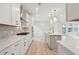 Modern kitchen with white cabinets, marble countertops, and gold fixtures at 135 Cantona Dr, Summerville, SC 29483