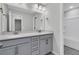 Double vanity bathroom with gray cabinets and a shower at 486 Green Fern Drive, Summerville, SC 29483