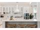 Bright white kitchen with island, stainless steel appliances, and white shaker cabinets at 134 Cantona Dr, Summerville, SC 29483