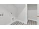 Bright laundry room with built-in shelving and patterned floor at 134 Cantona Dr, Summerville, SC 29483