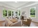 Bright living room with hardwood floors, large windows, and comfy seating at 418 Queenview Ln, Charleston, SC 29414