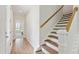 Elegant staircase with hardwood steps and a white railing at 418 Queenview Ln, Charleston, SC 29414