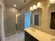 Bathroom features double sinks, quartz countertops, and a tiled shower stall at 479 Green Fern Dr, Summerville, SC 29483