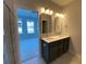 Bathroom with double sinks, quartz countertops and modern light fixtures at 479 Green Fern Dr, Summerville, SC 29483