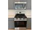 Close up of a stainless steel stove with overhead microwave at 479 Green Fern Dr, Summerville, SC 29483