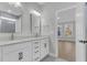 Bright bathroom with double vanity, white cabinets, gold fixtures, and marble-tiled shower at 385 Wappoo Trace Ln, Summerville, SC 29486