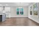 Bright dining area features hardwood floors, modern lighting and large windows offering natural light and scenic views at 385 Wappoo Trace Ln, Summerville, SC 29486