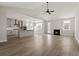 Open living room and kitchen with vaulted ceiling, fireplace, and luxury vinyl plank flooring at 379 Wappoo Trace Ln, Summerville, SC 29486