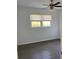 Bright bedroom with hardwood floors, a ceiling fan, and natural light from a window at 7700 Midwood Dr, North Charleston, SC 29420