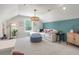 Bright bonus room with a blue accent wall, modern lighting, couch, and decor at 111 Ashley Cove Way, Summerville, SC 29483