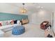 Cozy bonus room with a blue accent wall, a modern light fixture, couch, and accent chair at 111 Ashley Cove Way, Summerville, SC 29483