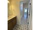 Bathroom with star pattern tile flooring, vanity, and open doorway to the tub at 502 Fiskdale Cir, Summerville, SC 29486