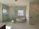 Bright primary bathroom featuring a walk-in shower and soaking tub at 502 Fiskdale Cir, Summerville, SC 29486