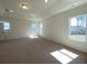 Spacious carpeted bedroom featuring tray ceiling, recessed lighting, and large windows at 502 Fiskdale Cir, Summerville, SC 29486