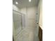 A bright, spacious shower with glass doors and marble-like tile flooring at 502 Fiskdale Cir, Summerville, SC 29486