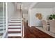 Interior view of a wooden staircase with white risers and dark wood treads at 208 Cherry Grove Dr, Summerville, SC 29483