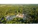 Aerial view of a new home community surrounded by lush trees and a pond at 327 Dickerson Ln, Lincolnville, SC 29485