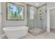 Luxurious bathroom with soaking tub, glass-enclosed shower, and a large window at 371 Wappoo Trace Ln, Summerville, SC 29486