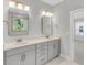 Bright bathroom with double sinks, quartz countertop, modern mirrors and fixtures at 371 Wappoo Trace Ln, Summerville, SC 29486