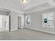 Spacious bedroom features a tray ceiling, two windows, and neutral color scheme at 371 Wappoo Trace Ln, Summerville, SC 29486