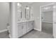 Bathroom featuring a double sink vanity, tile flooring, and a view into the bedroom at 383 Wappoo Trace Ln, Summerville, SC 29486