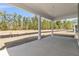 Covered patio with white support columns overlooking an expansive yard with trees at 383 Wappoo Trace Ln, Summerville, SC 29486