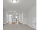 Bright hallway with hardwood floors, access to bathroom, and staircase with white banister and natural lighting at 710 Maynard Ln, Summerville, SC 29486