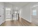 Light-filled hallway showcasing hardwood floors, white trim, leading to bedrooms and stairs with wooden handrail at 710 Maynard Ln, Summerville, SC 29486