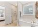 Clean bathroom with soaking tub, glass shower, and neutral tile at 130 Cantona Dr, Summerville, SC 29483