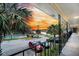 A view from the hallway over a parking area featuring palm trees, a pool and a view of the waterfront at 6240 Old Point Rd # C14, Hanahan, SC 29410