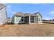 Exterior of a light green home with a screened-in porch and a spacious backyard at 719 Maynard Ln, Summerville, SC 29486