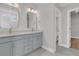 Bathroom features double sink vanity, granite counters, and decorative mirrors with modern light fixtures at 719 Maynard Ln, Summerville, SC 29486