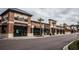 An exterior street view of shops in a brick mixed-use building with palm trees and a parking lot at 719 Maynard Ln, Summerville, SC 29486