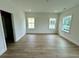 Bright bedroom with wood floors, a ceiling light, and two large windows at 180 Sandy Bend Ln, Summerville, SC 29486