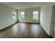 Spacious bedroom with wood floors, recessed lights, and three windows providing ample natural light at 180 Sandy Bend Ln, Summerville, SC 29486