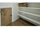 Walk-in pantry with wood floors and multiple built-in shelves provides ample storage space at 180 Sandy Bend Ln, Summerville, SC 29486