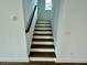 Stairway with dark wood treads and white risers leads to the upper level of the home at 180 Sandy Bend Ln, Summerville, SC 29486