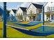 Relaxing hammocks in the yard offer a peaceful retreat with charming homes in the background at 407 Swaying Pine Ln, Summerville, SC 29486