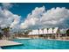 Community swimming pool surrounded by palm trees with ample lounging space at 407 Swaying Pine Ln, Summerville, SC 29486