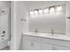 Bright bathroom features dual sinks, modern lighting, white cabinetry, and a shower at 704 Maynard Ln, Summerville, SC 29486