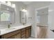 Bathroom with double sink vanity, brass fixtures, and a view into the adjacent bedroom at 704 Maynard Ln, Summerville, SC 29486