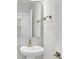 Elegant powder room with pedestal sink, gold fixtures, and a view of the adjacent hallway at 704 Maynard Ln, Summerville, SC 29486