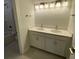 Bathroom featuring a double vanity with dual sinks and updated light fixtures at 704 Maynard Ln, Summerville, SC 29486