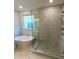 Luxury bathroom featuring a modern tub, glass enclosed shower with high-end fixtures and large window at 704 Maynard Ln, Summerville, SC 29486