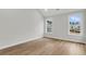 Bright bedroom features wood-look flooring and two windows that let in plenty of natural light at 704 Maynard Ln, Summerville, SC 29486