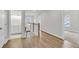 Hallway with wood flooring, natural light, a wooden railing, and a bathroom on the left at 704 Maynard Ln, Summerville, SC 29486