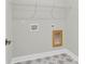 The laundry room features patterned tile flooring, a wire shelf, and hookups for a washer and dryer at 704 Maynard Ln, Summerville, SC 29486