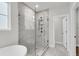 Contemporary shower with glass surround, rain shower head, and marble-look tile surround at 704 Maynard Ln, Summerville, SC 29486