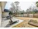 Fenced backyard featuring a concrete patio, lounge chair, and garden beds at 7034 Lanier St, Hanahan, SC 29410